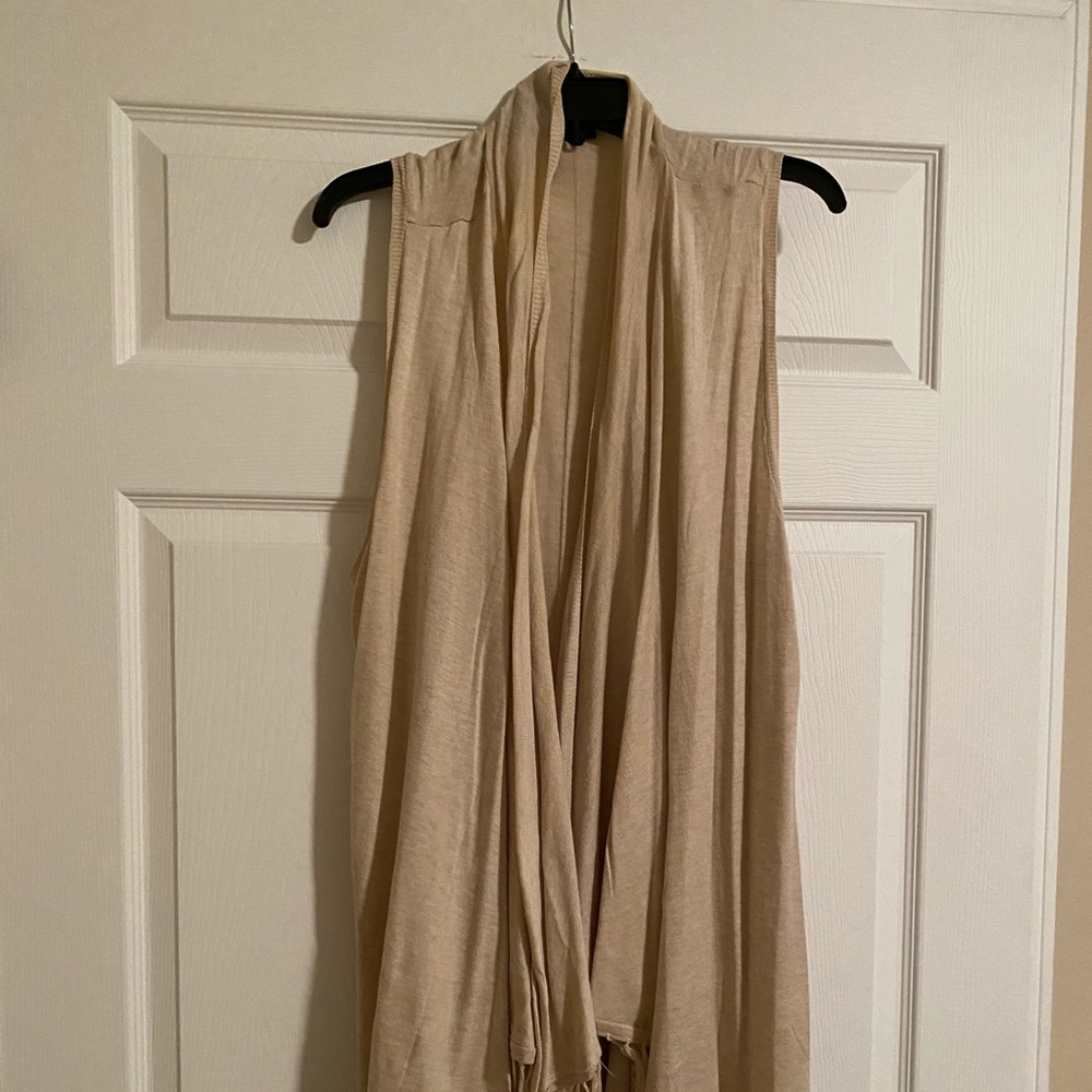 Tan cardigan with fringe.
